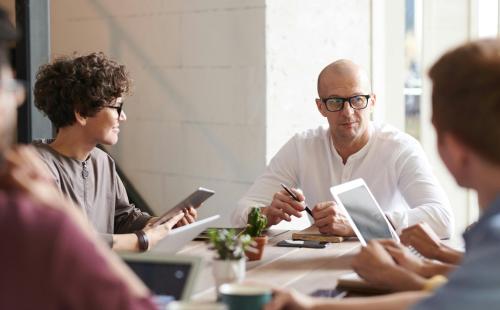 Adults discussing round a table