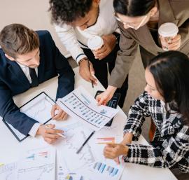 Professionals discussing around a desk